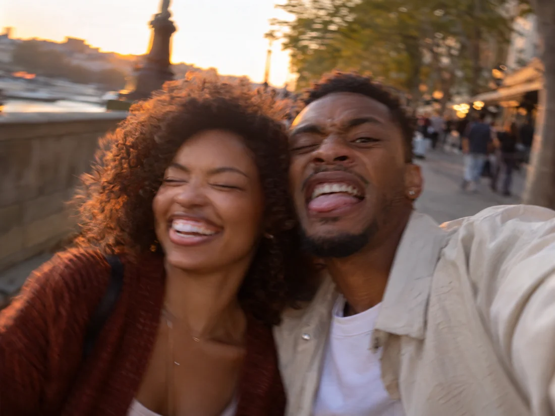 Two adults laughing together during a walk
